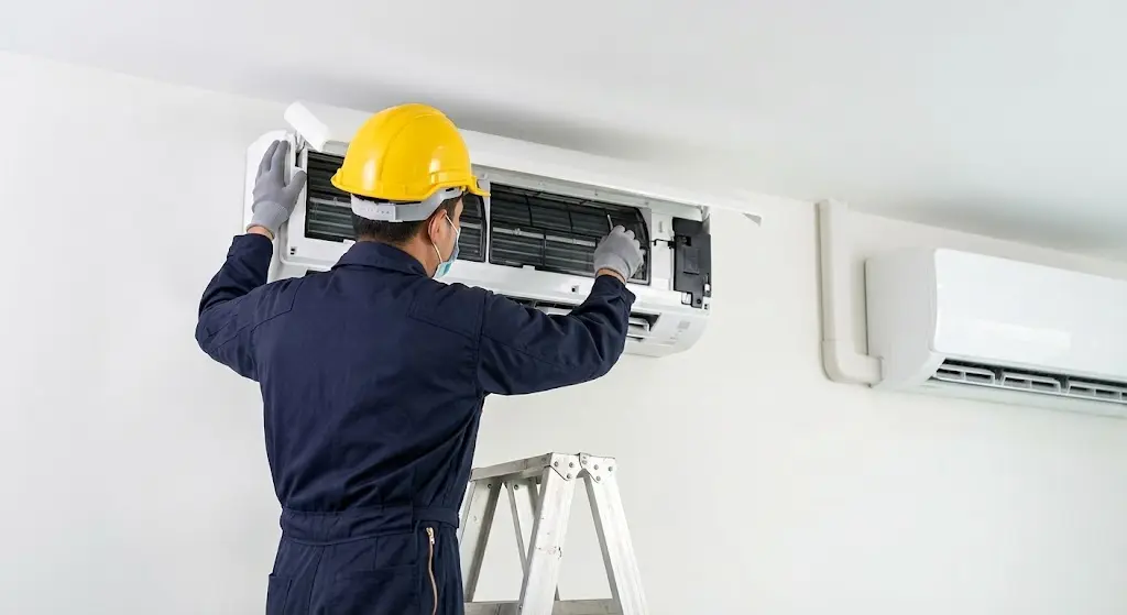 Air Conditioning in Kuala Lumpur — technician servicing indoor unit